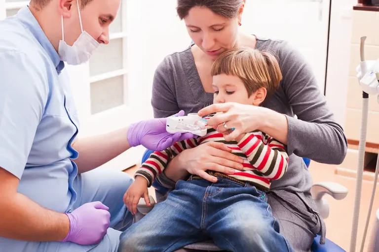 male-professional-showing-teeth-model-boy-clinic